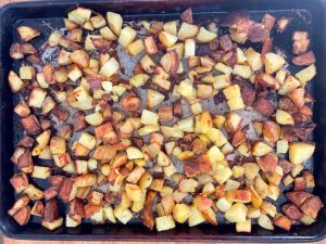Diced roast potatoes on a sheet pan