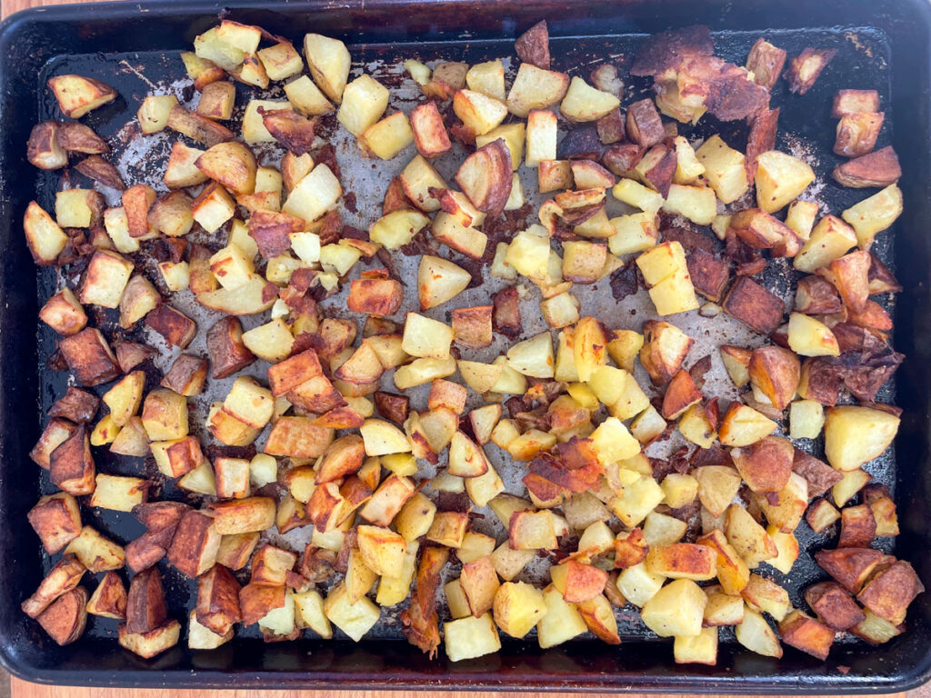 Diced roast potatoes on a sheet pan